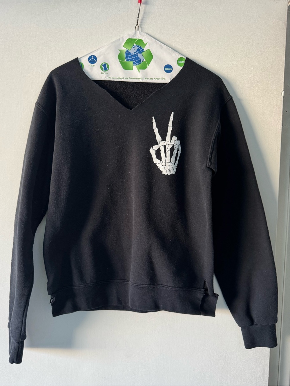 Black V-Neck women’s Sweater with White Skeleton Hand Graphic